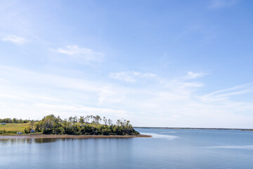 Fototapeta premium Coastal headland overlooking calm waters in Prince Edward Island Canada featuring natural shoreline open bay views and peaceful maritime scenery on a clear day