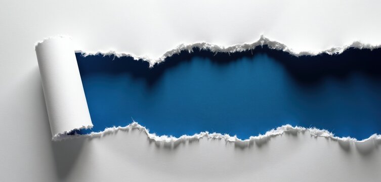 Torn white paper reveals deep blue void below. Jagged ripped edges and curled corner create dramatic contrast. Blank space offers copy area for design.