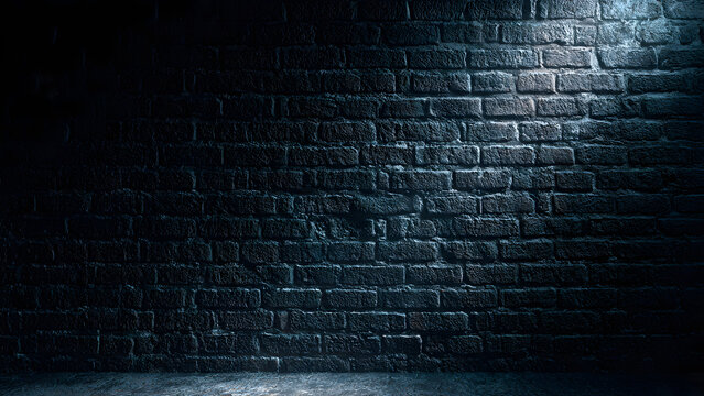 Dark brick wall with moody lighting in empty interior space