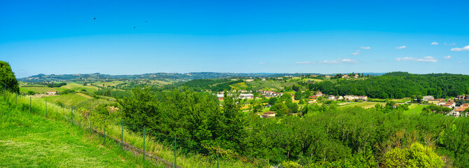 Naklejka premium Early summer panorama of the Orcia Valley. It's a countryside area in Tuscany (Italy), between Siena and Grosseto Provinces, world famous for its iconic landscapes, frequently used as movie locations.