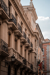Fototapeta premium Architecture of the city center of Madrid, Spain. Alley and narrow roads with Spanish balconies and design.