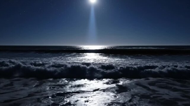 Ocean waves crashing on a sandy beach under a bright full moon at night