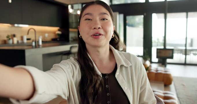 Happy, vlogging and face of woman in home with subscribers interaction on social media with app. Smile, talking and portrait of Asian female influencer with live streaming or recording video in house