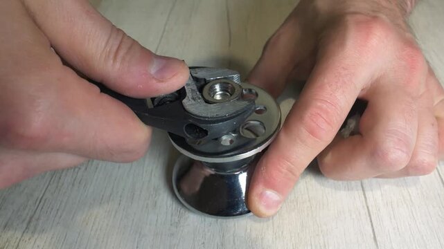 Tightening a nut with a wrench. A worker tightens a nut with a gas-powered adjustable wrench