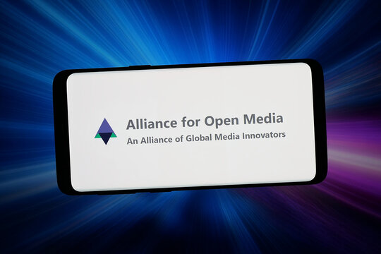 Stuttgart, Germany - 06-02-2026: In this photo illustration, the logo of consortium Alliance for Open Media (AOMedia) is displayed on a smartphone in front of abstract background on computer screen.