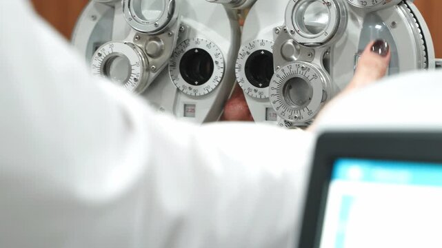 Elderly woman undergoing a sight test with a phoropter