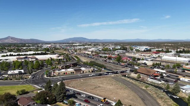 Wide aerial of US Highway 97 through rural Redmond Oregon downtown in spring