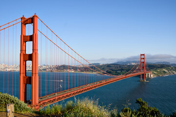 Fototapeta premium Golden Gate Bridge roadway leading across San Francisco Bay toward the city skyline
