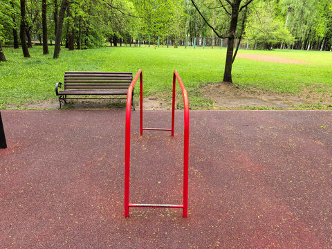 Red Metal Gymnastic Parallel Bars on Sports Ground