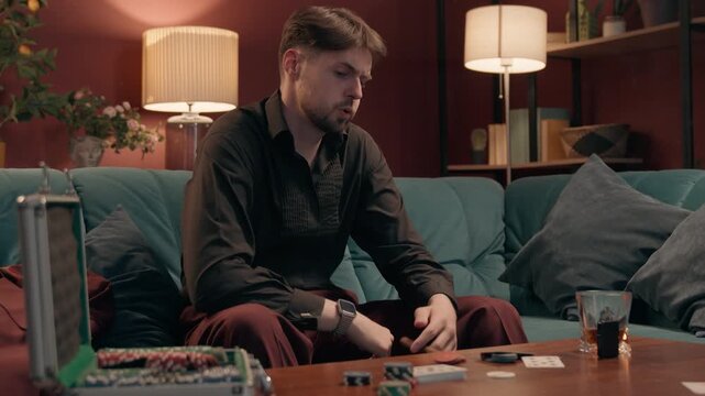 Frustrated Caucasian man gambler losing poker game throwing cards smoking cigar at home casino furious upset player male gamer guy playing stress lost bet failure problem debt gambling smoke addiction