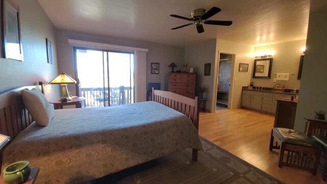 Bright hotel suite with balcony and warm lighting