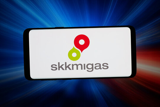 Stuttgart, Germany - 06-02-2026: In this photo illustration, the logo of Indonesian petroleum authority SKK Migas is displayed on a smartphone in front of abstract background on computer screen.