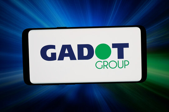 Stuttgart, Germany - 06-02-2026: In this photo illustration, the logo of Israeli chemical company GADOT Group is displayed on a smartphone in front of abstract background on computer screen.