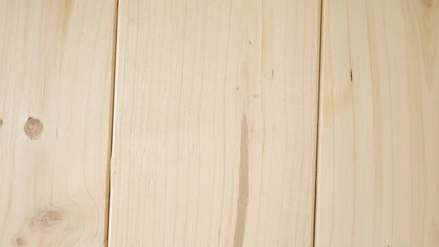 Light natural wood plank texture background slowly moving