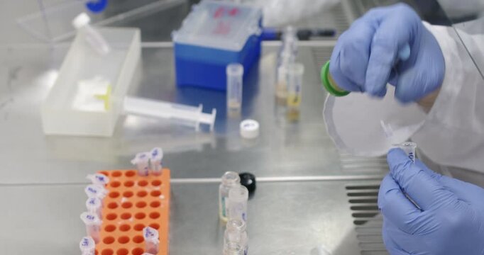 A scientist uses a disc filter to filter and purify an antibiotic. Laboratory experiment with liquid.
