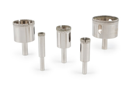 A diverse collection of industrial metalworking tools, including end mills, countersinks, and twist drill bits. Studio product photography on a polished white reflective surface.
