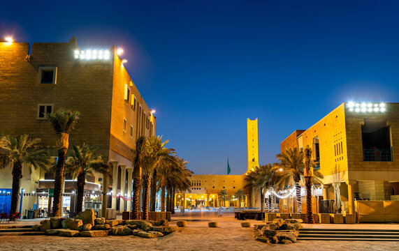 Night view of traditional Saudi architecture and palm trees at Deera Square in the historic Ad Dirah district of Riyadh, Saudi Arabia.