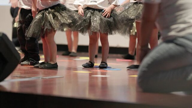 Young children in tutus performing on stage