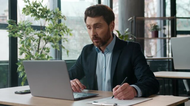 Caucasian businessman typing laptop speaking video call in office writing notes male manager HR employee entrepreneur CEO online meeting business man guy conference negotiations workplace corporate