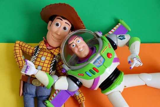 Salvador, Brazil - June 6, 2026: Sheriff Woody and Buzz Lightyear toys on a colorful background. Toy Story movie concept. 