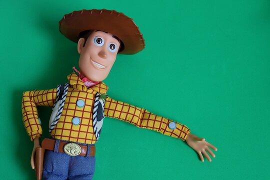 Salvador, Brazil - June 6, 2026: Sheriff Woody toy on a green background. Woody from Toy Story movie. 