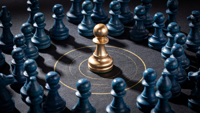 Shiny golden chess pawn standing in the center of dark blue wooden pieces on board