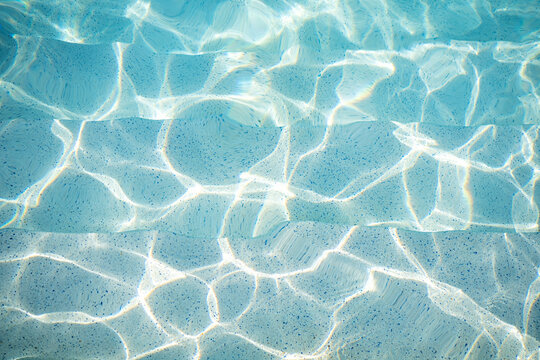 Ripple Water in Swimming Pool with Sun Reflection