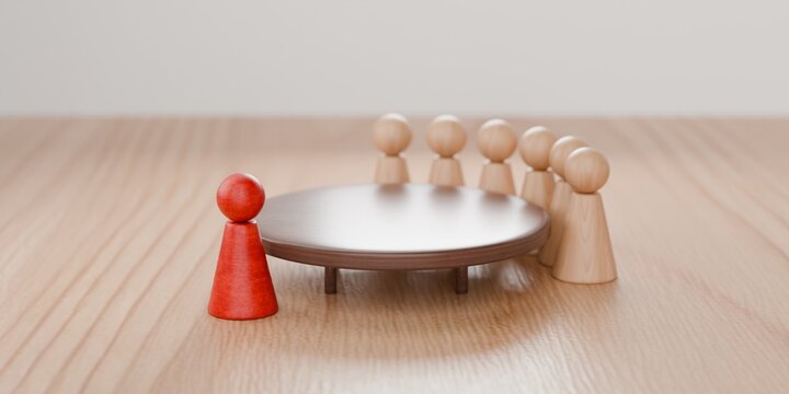 pawn figurines standing round a table, with one pawn highlighted in red. Corporate work environment, meeting, interview