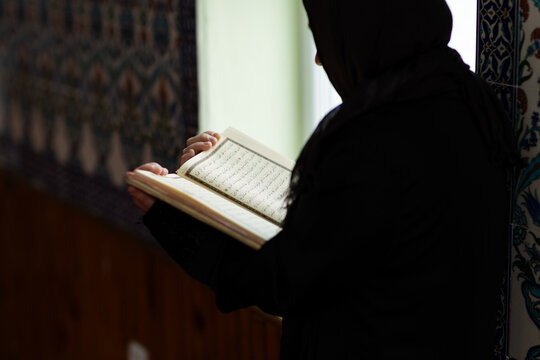 Muslim woman reading quietly inside a mosque