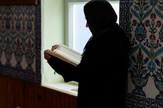 Muslim woman reading quietly inside a mosque