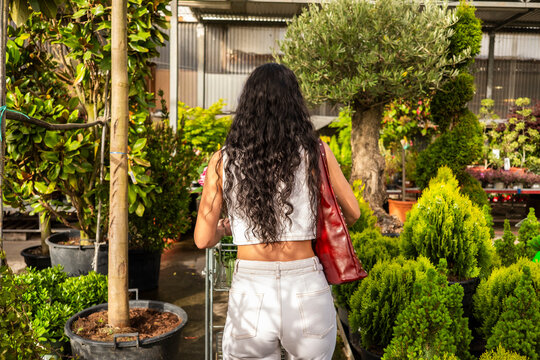 Woman enjoying spring gardening in vibrant garden center