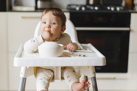 Baby enjoying first bites of complementary food