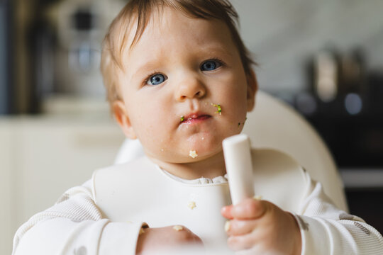 Baby enjoying complementary food at home