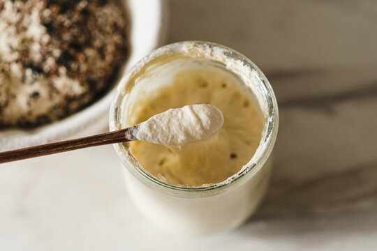 Rustic homemade sourdough starter in clear jar
