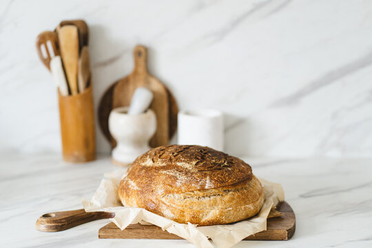 Rustic sourdough bread on wooden cutting board