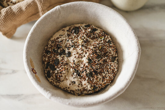 Rustic sourdough bread with seeds in a bowl