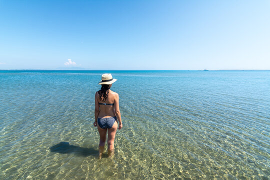 Woman wading in crystal water at Mediterranean beach