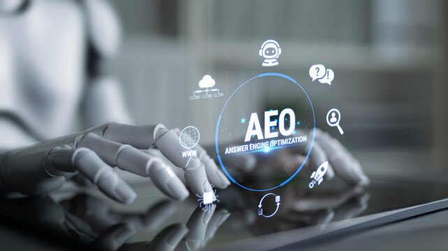 Futuristic robotic hand interacting with digital screen displaying AEO for answer engine optimization and various technology icons in a modern workspace Fluxor.