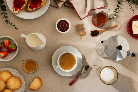 Continental breakfast table with coffee, pastry and jam