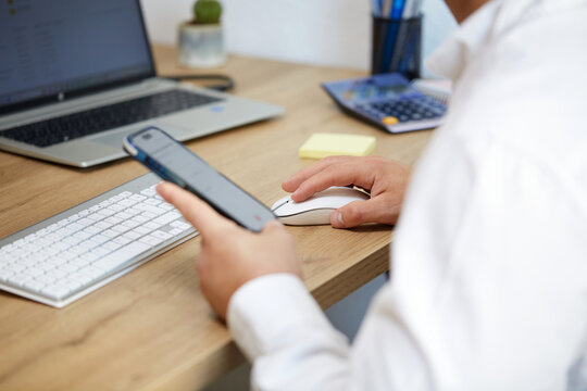 Office setup with smartphone and computer mouse