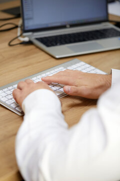 Professional typing hands using office keyboard