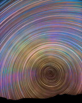Mesmerizing star trails over mountain landscape