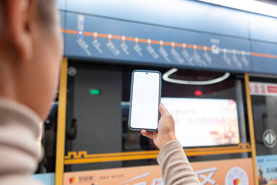 Person using smartphone in subway train