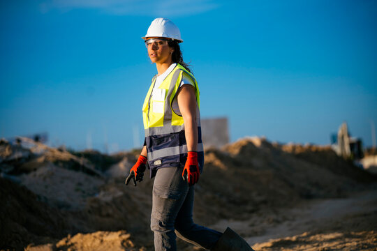 Female construction worker in safety helmet at site