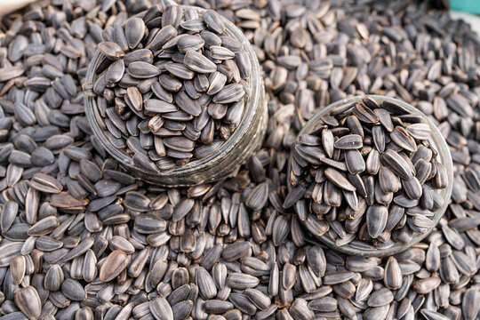 Close-up of sunflower seeds in glass jars on table