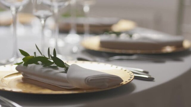 Elegant dining table setting with greenery and soft warm light