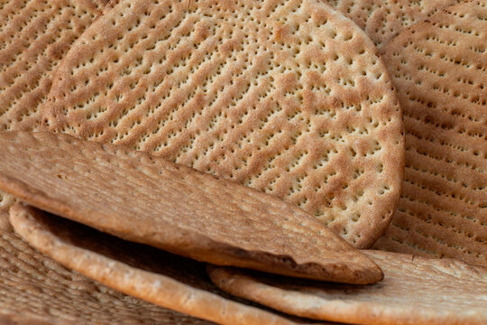 Traditional Uzbek flatbread close-up on rustic background