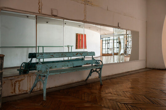 Abandoned Uzbek interior with mirrors, bench and parquet