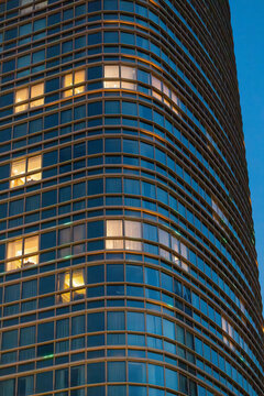 Modern curved glass tower facade at dusk in Uzbekistan