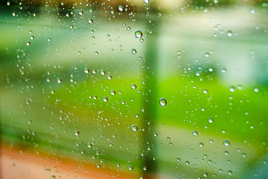 Water droplets on window pane create artistic effect